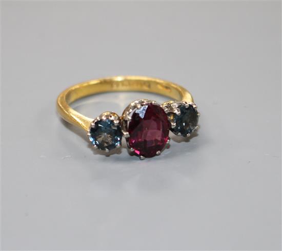 A 1930s 22ct gold, garnet and sapphire? three stone dress ring,